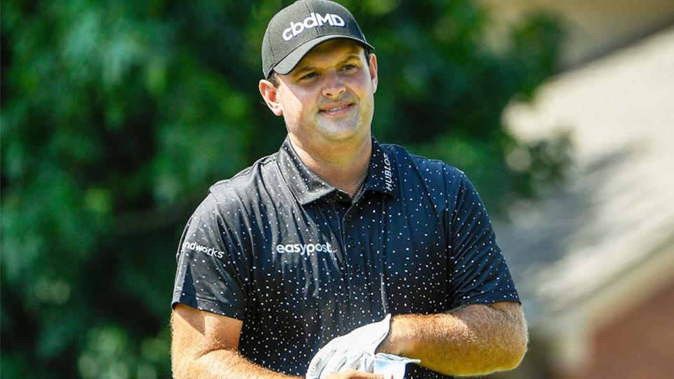 Patrick Reed (pictured) taking his gloves off after a shot.