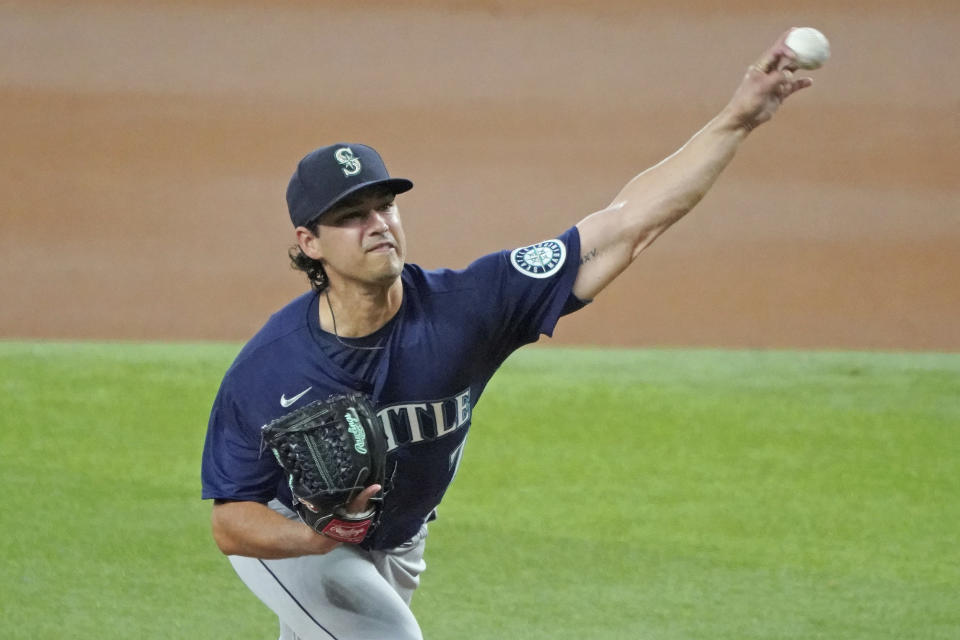 Seattle Mariners starting pitcher Marco Gonzales throws against the Texas Rangers in the first inning of a baseball game Sunday, Aug. 1, 2021, in Arlington, Texas. (AP Photo/Louis DeLuca)