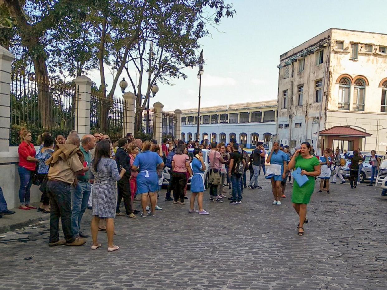 Workers leave their office building after the quake was felt in Havana, Cuba: AFP