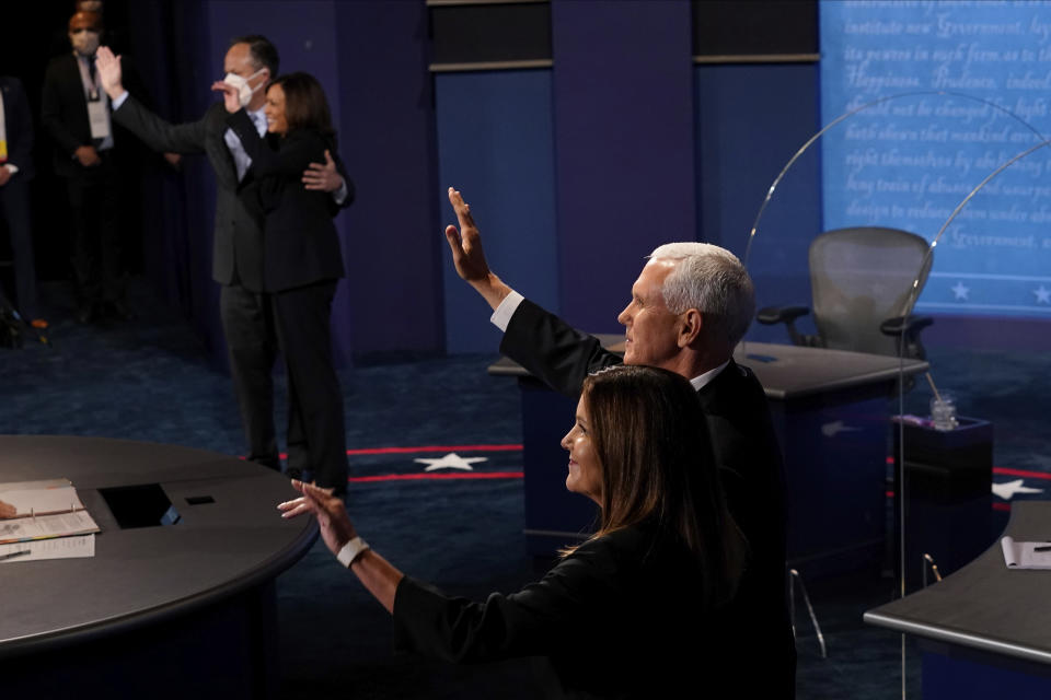 Democratic vice presidential candidate Sen. Kamala Harris, D-Calif., and her husband Doug Emhoff and Vice President Mike Pence and his wife Karen Pence wave to the audience after the vice presidential debate Wednesday, Oct. 7, 2020, at Kingsbury Hall on the campus of the University of Utah in Salt Lake City. (AP Photo/Morry Gash, Pool)