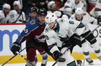 San Jose Sharks center Melker Karlsson, front, drives down the ice with the puck past Colorado Avalanche defenseman Samuel Girard during the second period of an NHL hockey game Thursday, Jan. 16, 2020, in Denver. (AP Photo/David Zalubowski)
