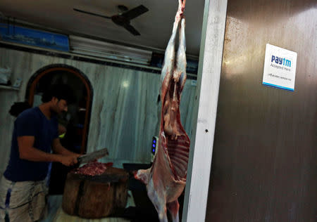 An advertisement of Paytm, a digital wallet company, is seen placed outside a meat shop in Kolkata, India, January 26, 2017. Picture taken January 26, 2017. REUTERS/Rupak De Chowdhuri