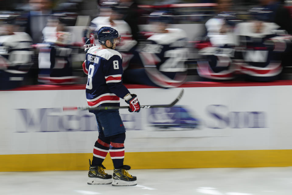 Washington Capitals left wing Alex Ovechkin (8) celebrates with teammates after his goal during the third period of an NHL hockey game against the Vancouver Canucks, Monday, Oct. 17, 2022, in Washington. (AP Photo/Jess Rapfogel)