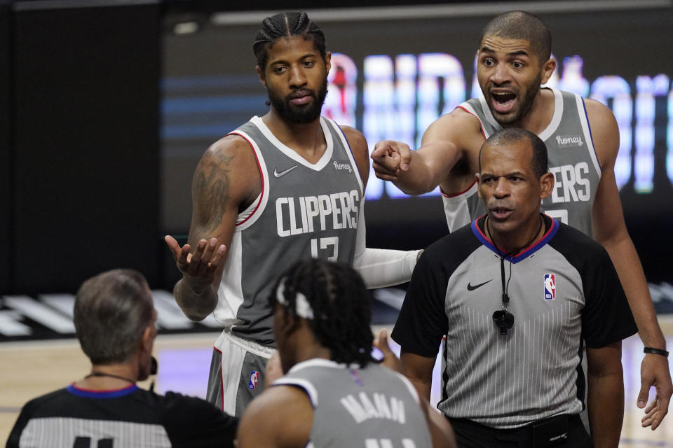 Los Angeles Clippers guard Paul George, left, and forward Nicolas Batum, right, question a foul call during the second half in Game 4 of the NBA basketball Western Conference Finals against the Phoenix Suns Saturday, June 26, 2021, in Los Angeles. (AP Photo/Mark J. Terrill)