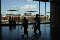 Globe Life Park, the former home of the Texas Rangers is visible through the windows of the of the new Globe Life Park as fans gather for Game 1 of the baseball World Series Series between the Los Angeles Dodgers and the Tampa Bay Rays Tuesday, Oct. 20, 2020, in Arlington, Texas. (AP Photo/Sue Ogrocki)