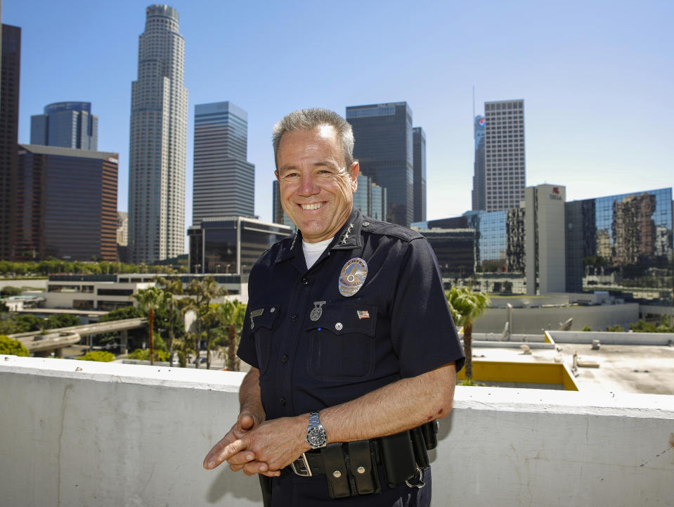 In this Wednesday, July 10, 2019, photo Los Angeles Police Department Chief Michel Moore poses for a photo in downtown Los Angeles. The Los Angeles police chief said he hopes in the coming weeks the city will eliminate old bench warrants for thousands of homeless people, a move he believes can be part of the solution to get part of the population off the streets. (AP Photo/Damian Dovarganes)