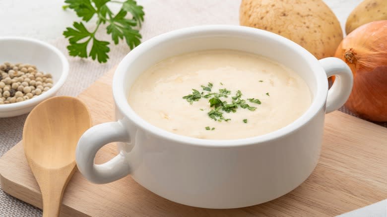 Creamy soup with wooden spoon
