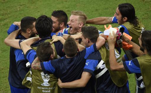 Italy's players celebrate at the end of their Group D match against England, at the Amazonia Arena in Manaus, during the FIFA World Cup, on June 14, 2014