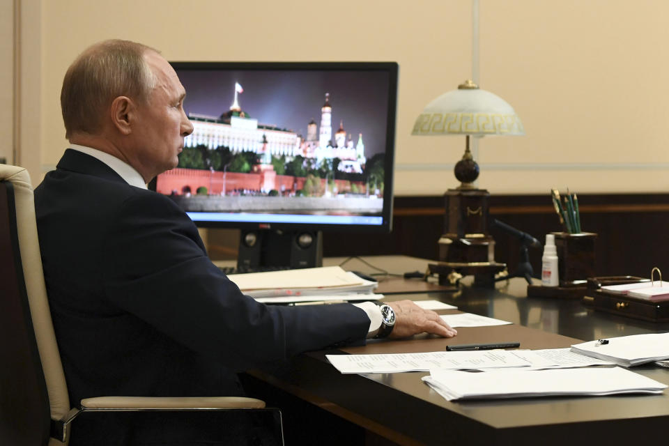 Russian President Vladimir Putin, addresses the nation via video conference at the Novo-Ogaryovo residence outside Moscow, Russia, Monday, May 11, 2020. Putin, speaking in a televised address to the nation Monday, said that it will be up to the governors of Russia's far-flung to determine what industrial plants could reopen starting Tuesday. He emphasized that it's essential to preserve jobs and keep the economy running provided that workers strictly observe sanitary norms. (Alexei Nikolsky, Sputnik, Kremlin Pool Photo via AP)