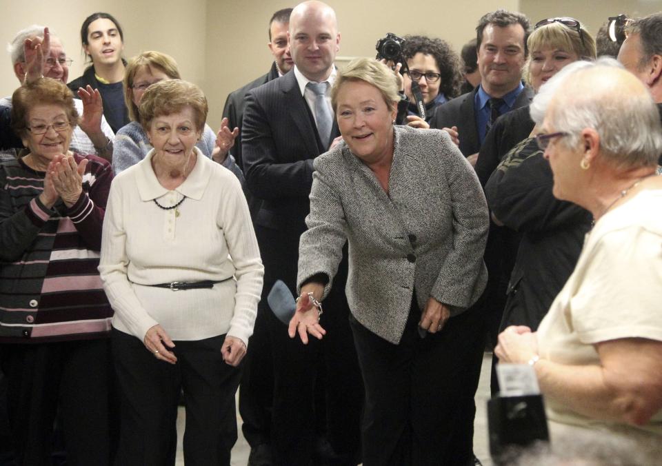 Parti Quebecois leader Pauline Marois throws a sandbag at a seniors centre during a campaign stop in Longueuil