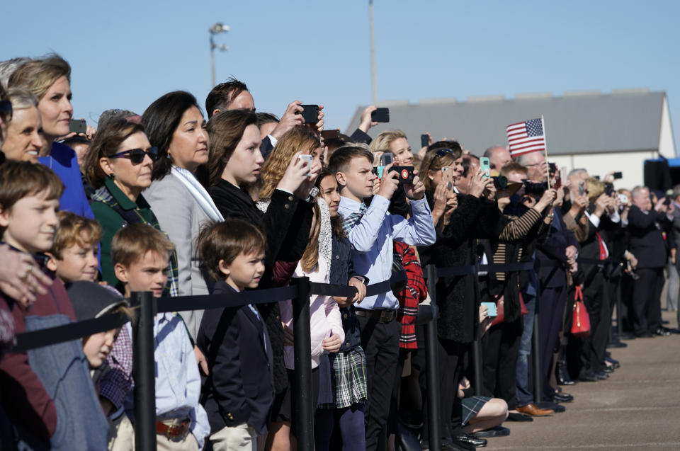 People watch the departure ceremony in Houston.