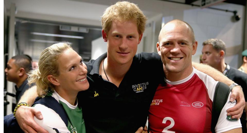 Zara Tindall smiles at cousin Prince Harry as they pose for a photo with Mike Tindall. (Getty Images)