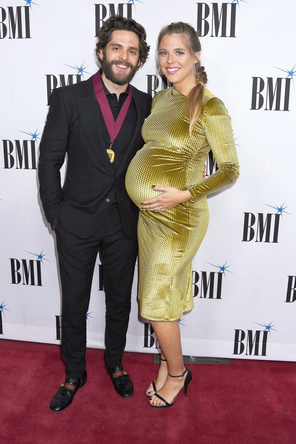 At the Nov. 12 BMI Country Awards in Nashville, Lauren — expecting the couple's third daughter in early 2020 — went for gold in her fitted knee-length frock.