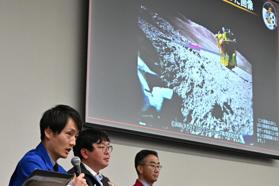 Daichi Hirnao (L), associate senior researcher at JAXA's Space Exploration Innovation Hub Center, explains  an image of the lunar surface taken and transmitted by LEV-2 