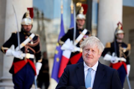 British Prime Minister Boris Johnson attends a joint statement with French President Emmanuel Macron before a meeting on Brexit at the Elysee Palace in Paris