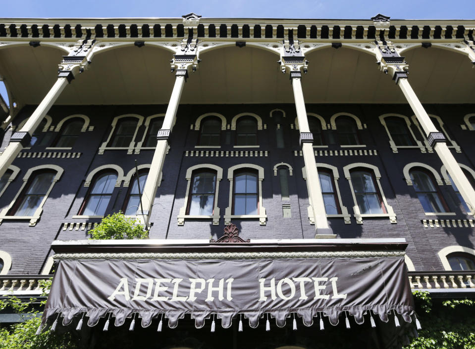 This May 17, 2013 photo shows the exterior of the Adelphi Hotel in Saratoga Springs, N.Y. Saratoga Springs' racetrack is still going strong as it marks its 150th anniversary this summer, the centerpiece attraction in a town that's also known for mineral springs, Victorian charm and upscale hotels, shops and restaurants. (AP Photo/Mike Groll)