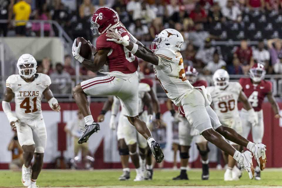 Alabama wide receiver Kobe Prentice (6) catches a pass as Texas defensive back Kitan Crawford (21) defends during the first half of an NCAA college football game, Saturday, Sept. 9, 2023, in Tuscaloosa, Ala. (AP Photo/Vasha Hunt)