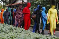 Participants wearing Zentai costumes, or skin-tight bodysuits from head to toe, take part in a march down the shopping district of Orchard Road during Zentai Art Festival in Singapore May 23, 2015. Close to 50 participants strutted down the busy shopping district during the Zentai art festival which is jointly organized by the Japanese embassy. The festival includes performances and discussions on Zentai from May 22 to from June 5. REUTERS/Edgar Su