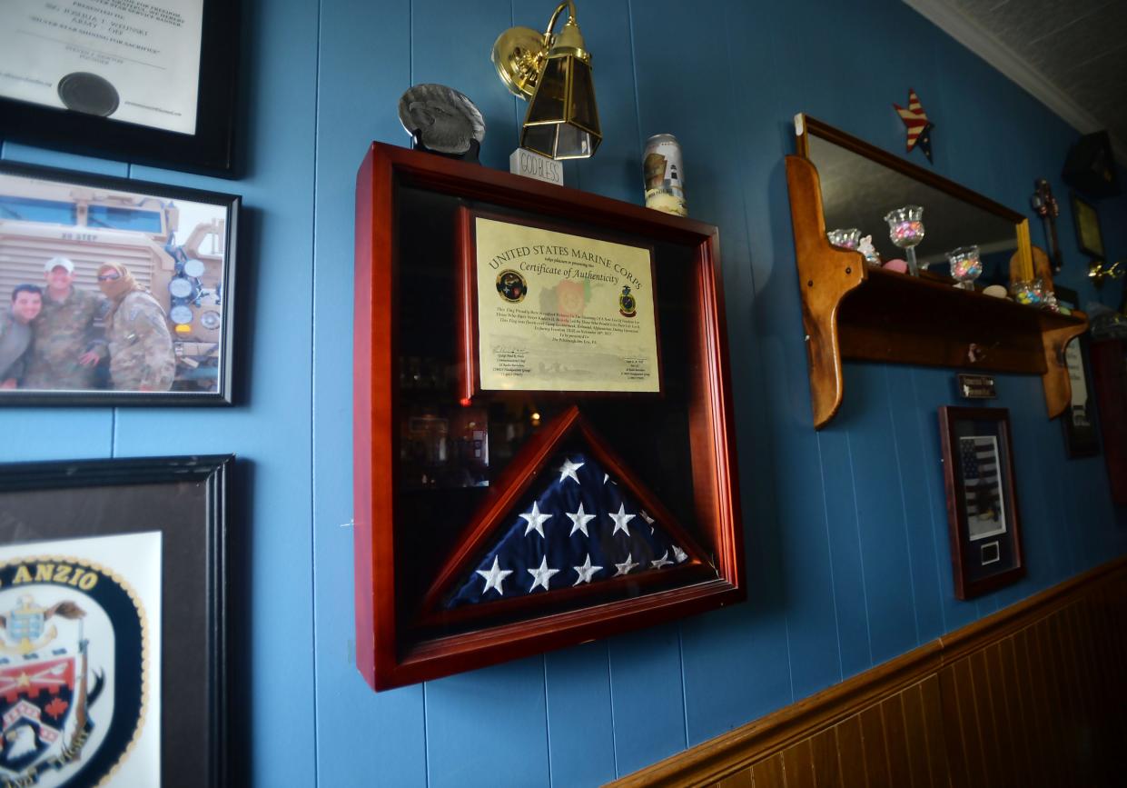 Flags and other military items from service members adorn the walls of the Freedom Room at the Pittsburgh Inn.