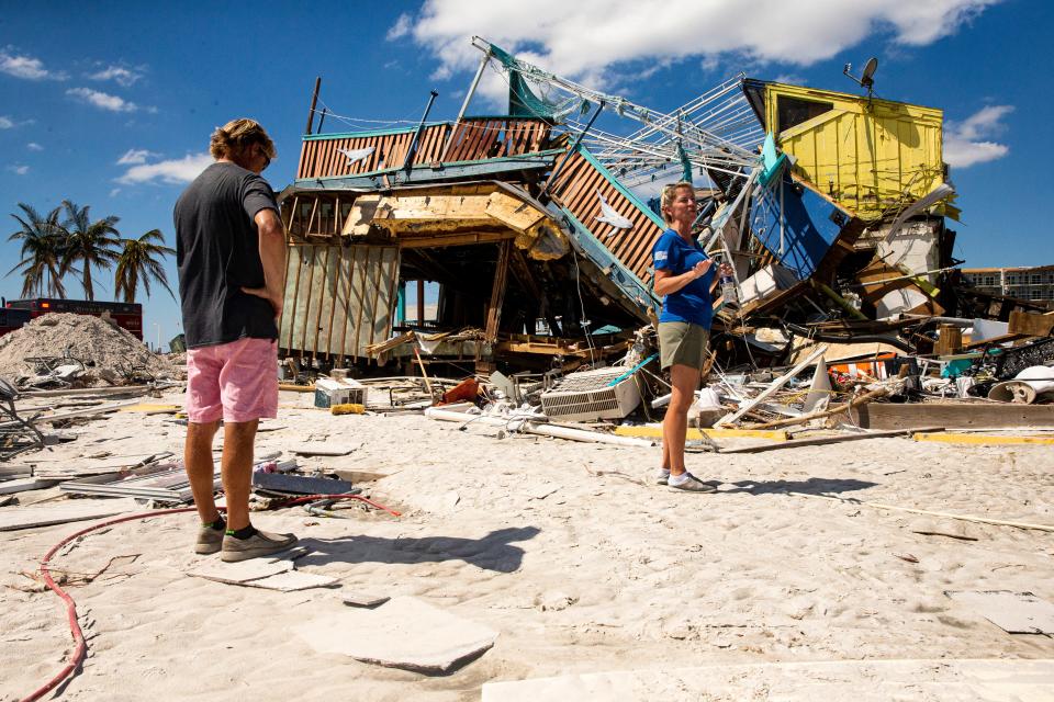 Fort Myers Beach residents and Whale restaurant owners Mike and Dawn Miller survey the destruction Saturday, October 8, 20222 caused by Hurricane Ian. It was the first time they were able to see the damage first hand since the hurricane made landfall. 