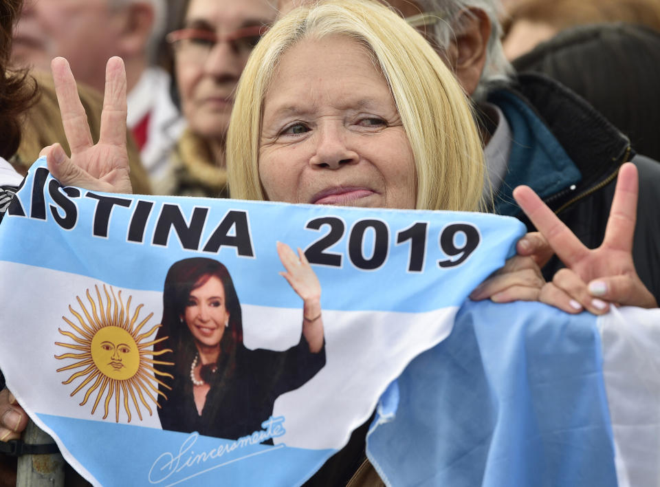 A supporters of presidential candidate Alberto Fernandez and his running-mate, former President Cristina Fernandez, no relation, holds a banner that show an image of the former leader, during the kick-off political campaign rally,at the Nestor Kirchner Park, in Buenos Aires, Argentina, Saturday, May 25, 2019. Argentina will hold general presidential elections on Oct 27.(AP Photo/Gustavo Garello)