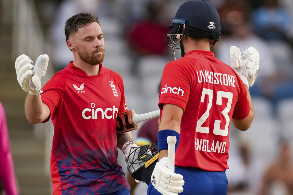 England's Phil Salt celebrates with Liam Livingstone scoring a century against West Indies during the fourth T20 cricket match at Brian Lara Stadium in Tarouba, Trinidad and Tobago, Tuesday, Dec. 19, 2023. (AP Photo/Ricardo Mazalan)