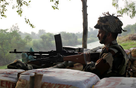 An Indian army soldier keeps guard from a bunker near the border with Pakistan in Abdullian, southwest of Jammu, September 30, 2016. REUTERS/Mukesh Gupta/File Photo