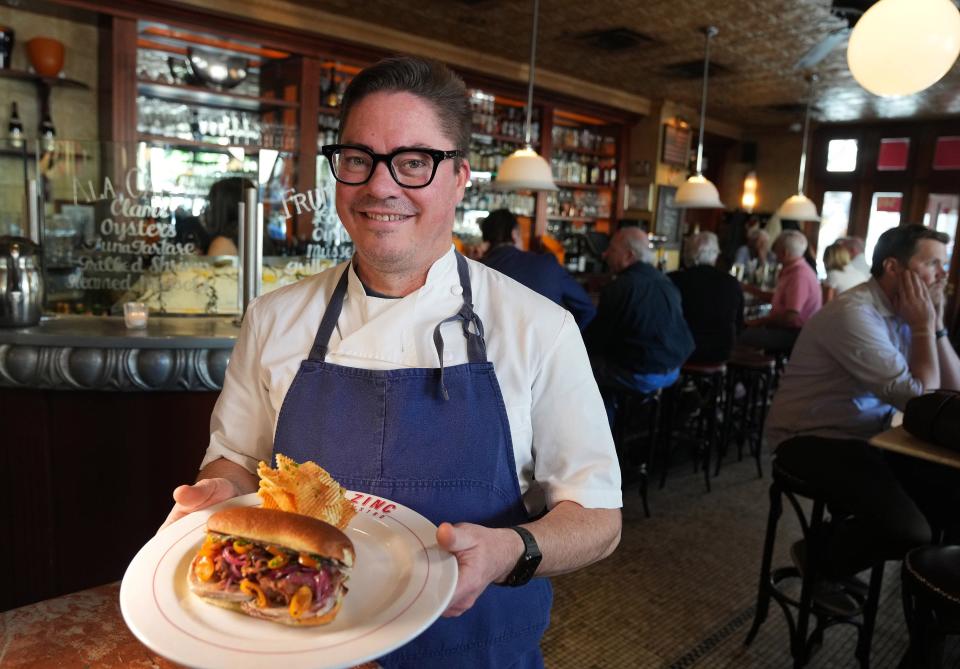 Feb 18, 2022; Scottsdale, Arizona, United States;  Chef Matt Carter from Zinc Bistro, in Scottsdale, creates a duck confit sandwich. Mandatory Credit: Cheryl Evans-Arizona Republic