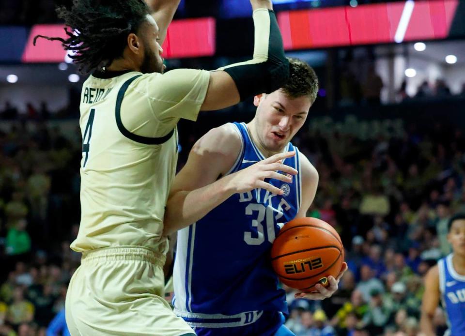 Duke’s Kyle Filipowski (30) tries to work around Wake Forest’s Efton Reid III (4) during the first half of Duke’s game against Wake Forest at Lawrence Joel Veterans Memorial Coliseum in Winston-Salem, N.C., Saturday, Feb. 24, 2024.