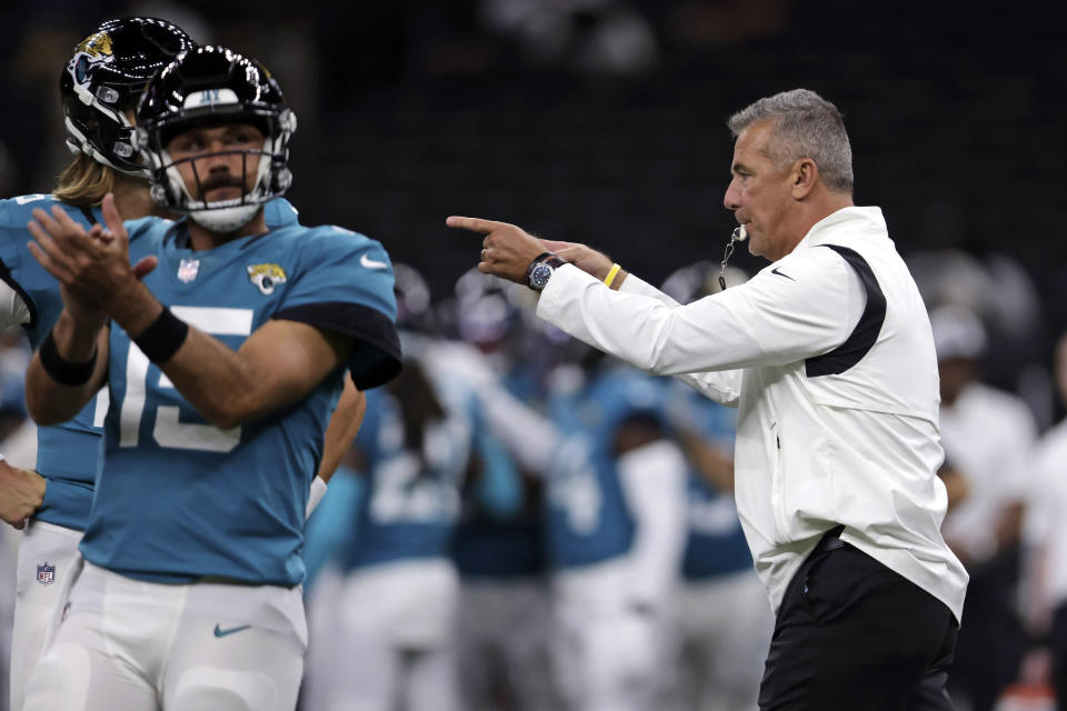 FILE - In this Monday, Aug. 23, 2021, file photo, Jacksonville Jaguars head coach Urban Meyer directs his team as they warm up for a preseason NFL preseason football game against the New Orleans Saints in New Orleans. In many regards, Meyer runs the Jaguars like a college program It’s what he knows even though he spent a year studying the NFL before he ended a brief coaching retirement. It’s also worked at every previous stop, so no one is questioning his methods. (AP Photo/Brett Duke, File)