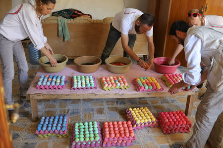 Volunteers prepare painted eggs during celebrations after the Easter Mass in Mar Gewargis (St George) Chaldean Catholic church, which was damaged by Islamic State militants, in the town of Tel Esqof, Iraq, April 16, 2017. REUTERS/Marko Djurica