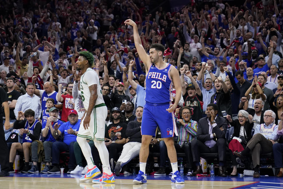 Philadelphia 76ers' Georges Niang (20) reacts after making a shot against Boston Celtics' Marcus Smart during the second half of Game 6 of an NBA basketball playoffs Eastern Conference semifinal, Thursday, May 11, 2023, in Philadelphia. (AP Photo/Matt Slocum)
