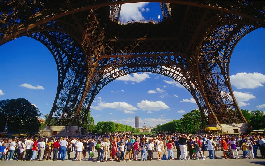 Tourists queue at the Eiffel Tower - This content is subject to copyright.