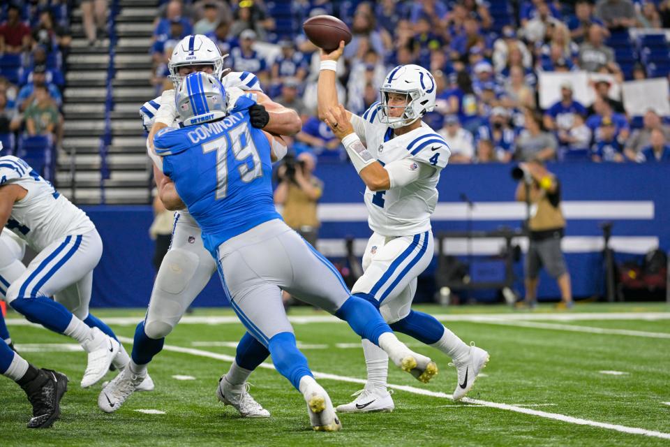 Indianapolis Colts quarterback Sam Ehlinger throws as Detroit Lions defender John Cominsky pressures during the second half of an NFL preseason football game in Indianapolis, Saturday, Aug. 20, 2022.