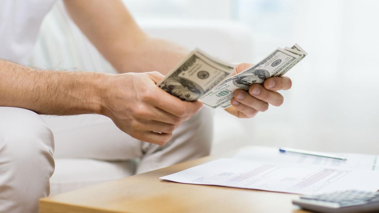 man counting USD money