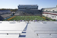 Players run on the field during the opening kickoff of an NCAA college football game between Iowa and Northwestern, Saturday, Oct. 31, 2020, in Iowa City, Iowa. (AP Photo/Charlie Neibergall)