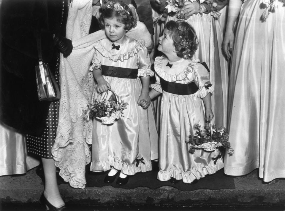 <p>Camilla, 4, and her sister Annabelle, 3, carry out bridesmaids duties at the wedding of Jeremy Cubitt and Diana du Cane in St. Mark's church in London. Camilla (now known as Camilla Parker Bowles, or Camilla, Duchess of Cornwall) would meet Charles while in their teens in the 1970s.</p>