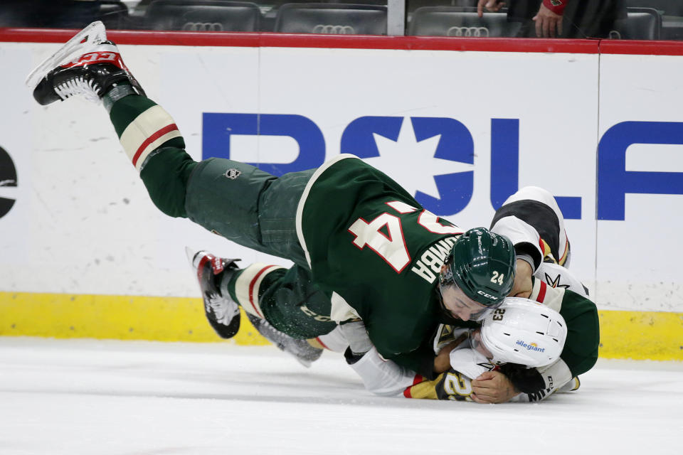 Minnesota Wild defenseman Matt Dumba (24) and Vegas Golden Knights defenseman Alec Martinez (23) fight during the second period in Game 6 of an NHL hockey Stanley Cup first-round playoff series Wednesday, May 26, 2021, in St. Paul, Minn. (AP Photo/Andy Clayton-King)