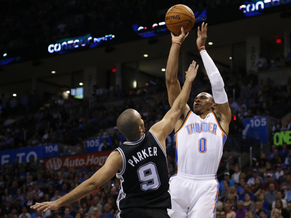 Oklahoma City Thunder guard Russell Westbrook (0) shoots over San Antonio Spurs guard Tony Parker (9) during the first quarter of an NBA basketball game in Oklahoma City, Thursday, April 3, 2014. (AP Photo/Sue Ogrocki)