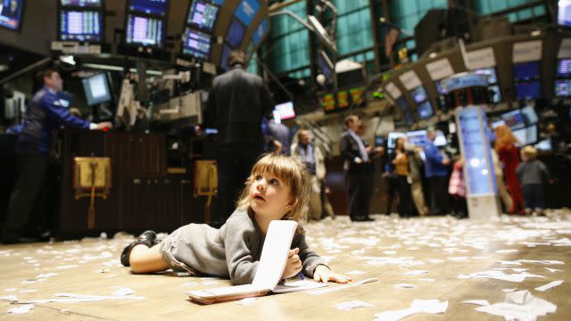 Gabriella Liloia lies on the trading floor, during kid's day at the New York Stock Exchange November 27, 2009. The New York Stock Exchange allowed children on the floor during the shortened trading day. REUTERS/Brendan McDermid