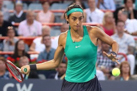 Aug 10, 2018; Montreal, Quebec, Canada; Caroline Garcia of France hits a shot against Simona Halep of Romania (not pictured) during the Rogers Cup tennis tournament at Stade IGA. Mandatory Credit: Jean-Yves Ahern-USA TODAY Sports