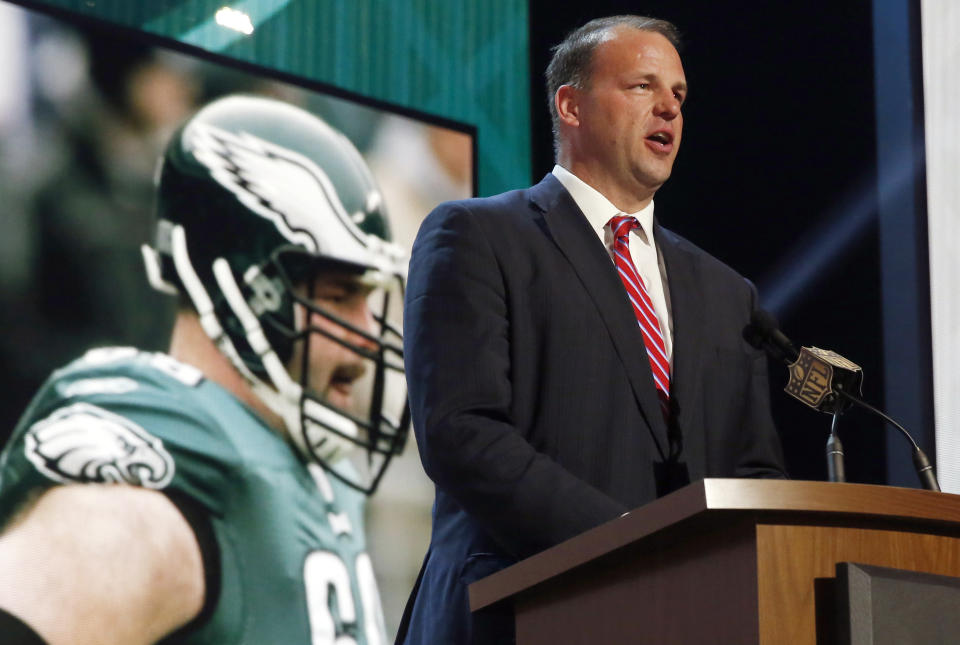 Jon Runyan, shown here announcing an Eagles draft pick in 2015, drives an Uber in his spare time. (AP)