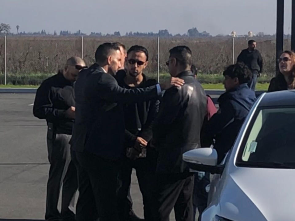 Ali Hassan, center in sunglasses, and his father gather outside the mosque where prayers were held before the burial of his 2-year-old son, Abdullah, in Lodi, Calif., Saturday, Dec. 29, 2018. Mourners gathered Saturday at a mosque to say goodbye to the boy whose Yemeni mother successfully fought the Trump administration's travel ban to hold the dying boy again in the United States. (AP Photo/Daisy Nguyen)