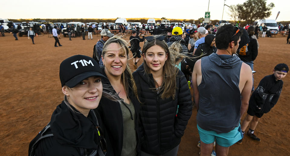 (L-R) Tourists from Victoria, Madison, Kelly and Georgia Derks are seen lining up to climb Uluru. source: AAP