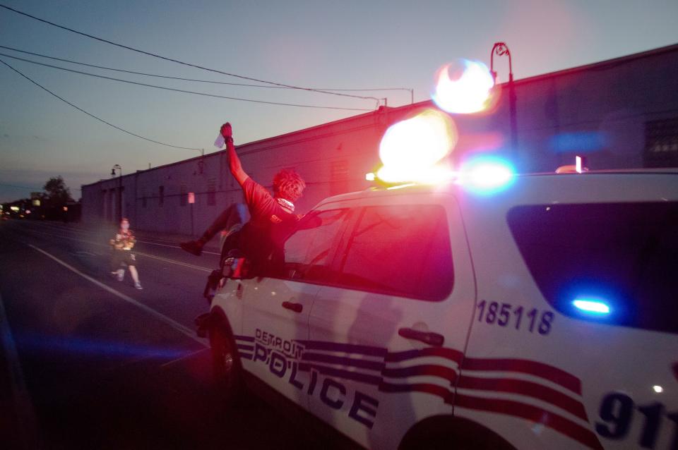 A protester is shown on the hood of a Detroit Police Department SUV before being thrown from the vehicle on Vernor Highway on Sunday, June 29.