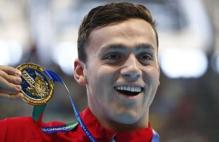 Britain's James Guy celebrates with his gold medal after winning the men's 200m freestyle final at the Aquatics World Championships in Kazan, Russia, August 4, 2015. REUTERS/Hannibal Hanschke