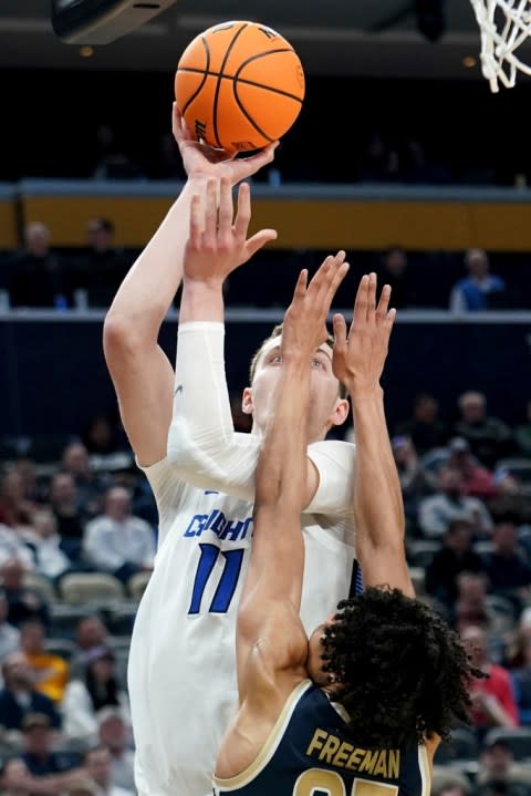 Creighton’s Ryan Kalkbrenner (11) shoots over Akron’s Enrique Freeman (25) during the second half of a first-round college basketball game in the NCAA Tournament, Thursday, March 21, 2024, in Pittsburgh. (AP Photo/Matt Freed)