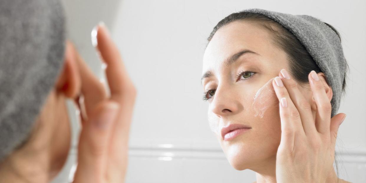 woman putting on face cream