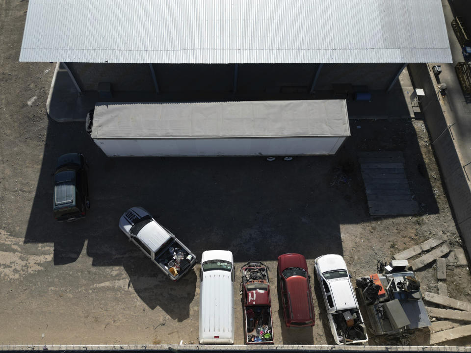 A refrigerated trailer truck is parked outside the morgue, known as the Forensic Medical Services (SEMEFO), where the bodies of migrants who died in a fire at an immigration detention center the previous day were taken in Ciudad Juarez, Mexico, Wednesday, March 29, 2023. (AP Photo/Christian Chavez)