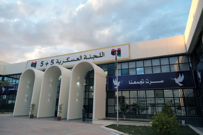 A security man stands at the entrance to the meeting hall of the 5+5 Military Committee in Sirte